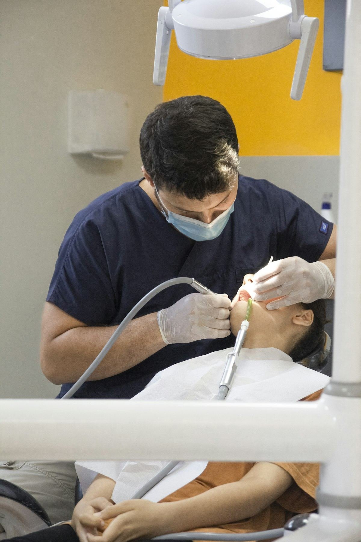 Dental clinician performing a precise procedure with gloved hands